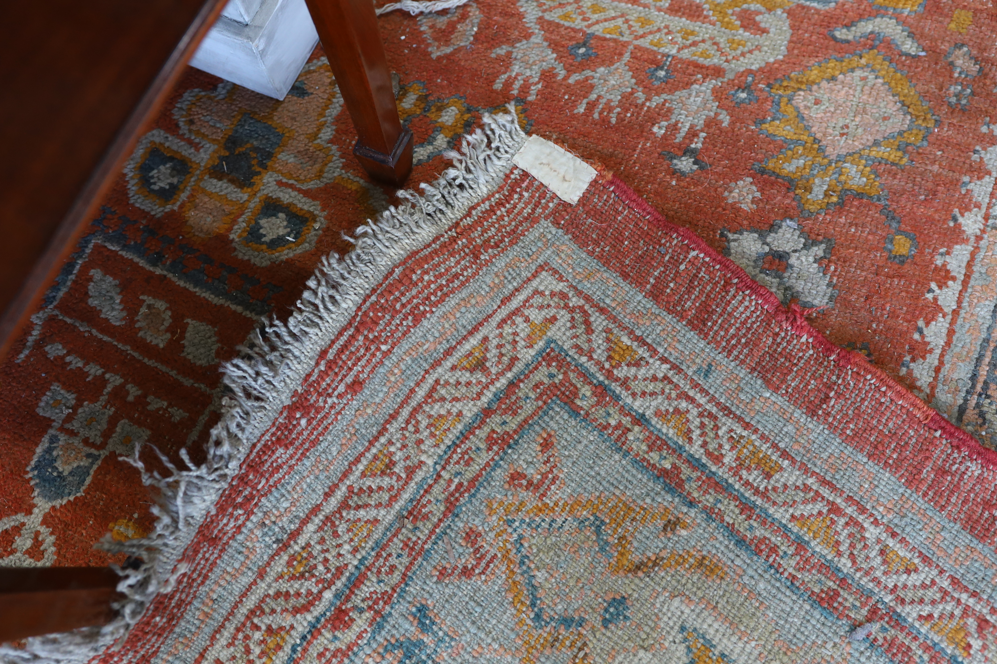An Afghan red ground carpet, 395 x 310cm